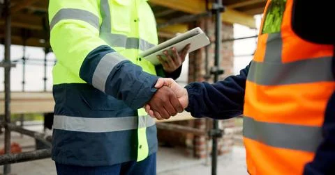 Men, shaking hands and tablet on construction site for agreement, developme.. Stock Photos