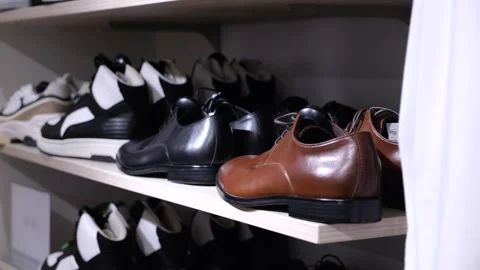 Men shoes on shelf in store. Medium shot: brown men shoes on shelf in store, in Stock Footage 270005294