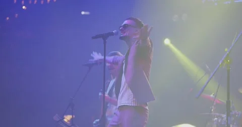 Men singing to microphone on light background. Stylish cool guy performing Stock Footage 195545550