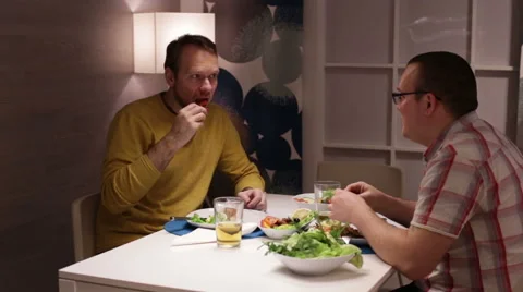 Men sit at table, eating drinking beer and talking Video stock 58103980