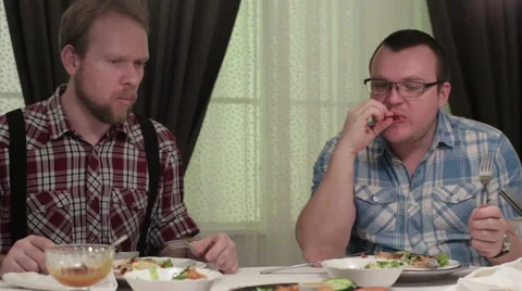 Men sitting at the dinner table in a cafe Stock Footage 62846760