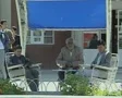 Men sitting outside station SD Footage