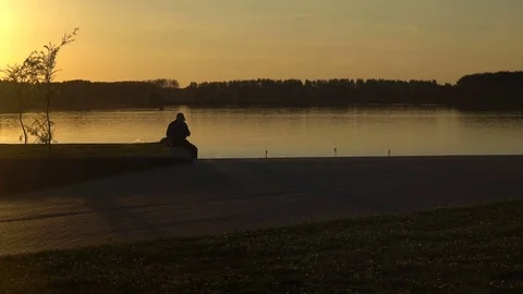 Men is sitting in the sunset Video stock 80367344