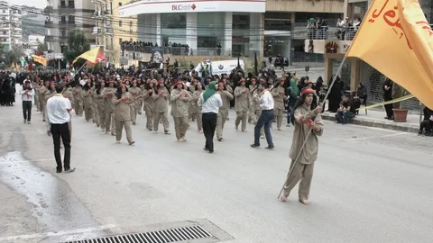 Men slap their chests during Hezbollah's Ashoura procession in Nabatieh, Lebanon Stock Footage 119947936