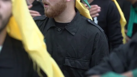 Men slap their chests during Hezbollah's Ashoura procession in Nabatieh, Lebanon Stock Footage 120589857