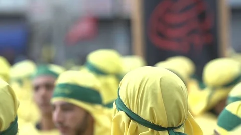 Men slap their chests during Hezbollah's Ashoura procession in Nabatieh, Lebanon Stock Footage 120590102