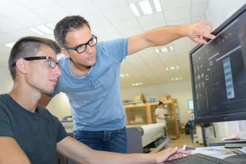 Men in spectacles looking at computer Stock Photos