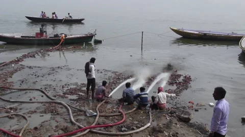 Men Spraying Hoses Into The Ganges River In Varanasi, India Stock Footage 159174313