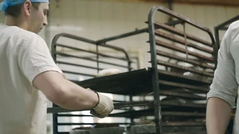 Men spread bread from molds Video stock 76879616