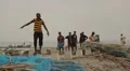 Men from Sri Lanka walking on the shoreline HD Footage