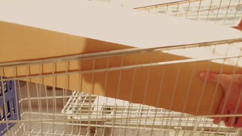 Men stack large cardboard box with furniture in shopping trolley in self-se.. 스톡 동영상 245816130