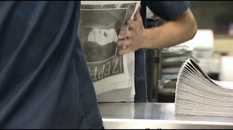 Men Stacking Newspapers Stock Footage 93874507