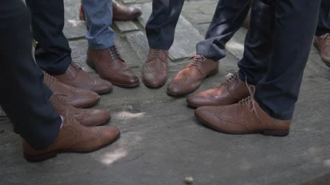 Men stand in a circle in brown stylish shoes. Stock Footage 133360034