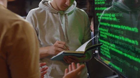 Men Standing by Screen with Codes on It Stock Footage 99470683