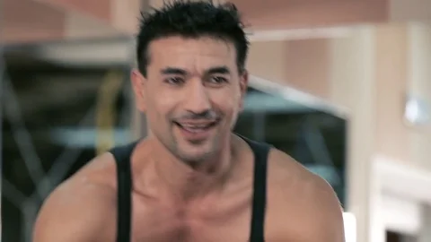 Men is on the stationary bicycle. Stock Footage 80438035