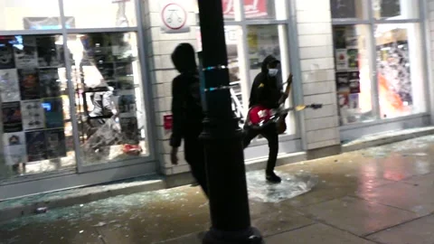 Men steal guitars right in front of camera during stunning looting incident Stock Footage 137553048