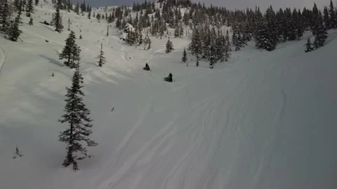 Men on a steep slope ride on mountain snowmobiles Stock Footage 170924835