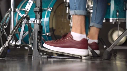 Men is stepping on the drum pedal. Guy press the drum pedal. hitting the drum Stock Footage 155554427