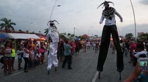 Men on Stilts in Parade at Carnival Stock Footage 46906554