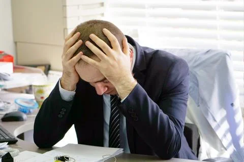 Men stressed out at work Foto stock