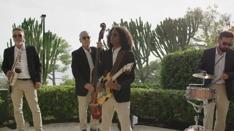 Men in suits performing catchy music with instruments outdoors Stock Footage 321445085