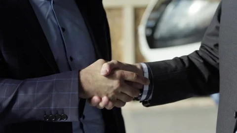 Men in suits shake hand and bump fist right to left Stock Footage 124243579