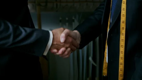 Men in suits shaking hands Stock Footage 93972059