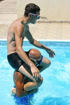 Men in swimming pool Stock Photos