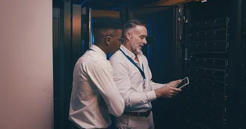 Men, tablet and discussion in server room with inspection, review and system 스톡 사진