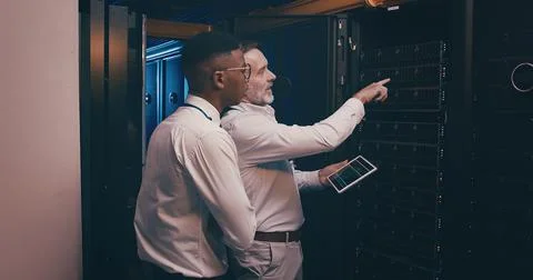 Men, tablet and team in server room with inspection, point and talk with mentor Stock Photos
