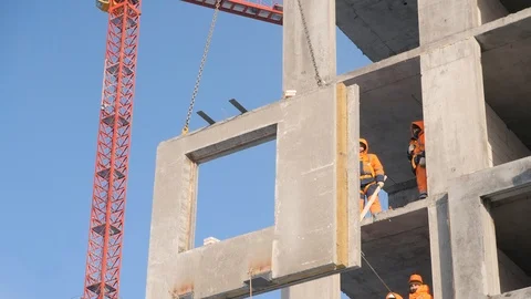 Men take part in concrete panel installation lifted by crane Stock Footage 124892383