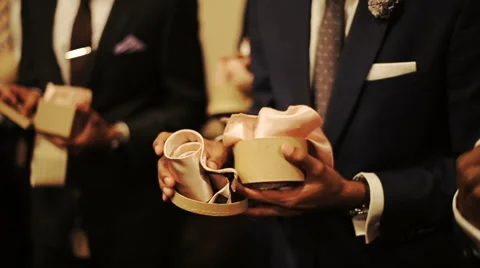 Men take pink silk ties from the box Stock Footage 68995869