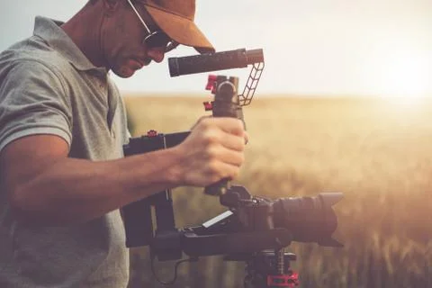 Men Taking Video Shot Using Digital Camera and Gimbal Stabilizator Stock Photos