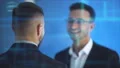 The men talk and pat shoulder on the hologram background. slow motion 4k or 4k+ Resolution