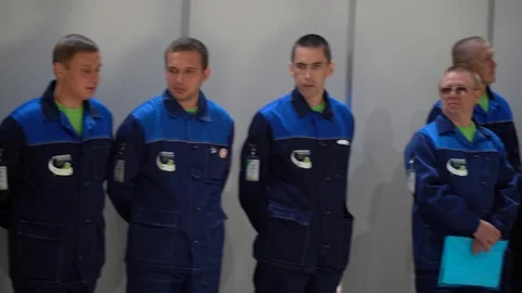 Men talk to each other, some stand in silence. Employees guys wait working day Stock Footage 126355289