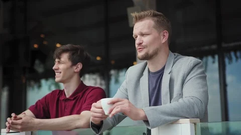 Men talking on balcony at coffee break Stock Footage 111756950