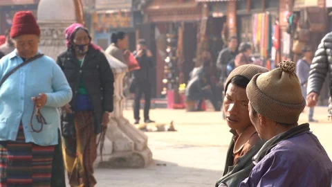 Men Talking on a Bench in at Boudhanath Stupa in Kathmandu, Nepal Видео 86884309