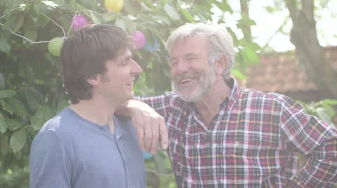 Men talking with each other in garden, family generation Stock Footage