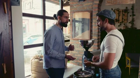 Men tasting coffee beans from the roasting machine Stock Footage 95911456