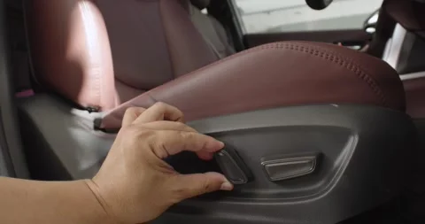 Men test buttons for electric adjustment of seats in the car. Stock Footage 244394981