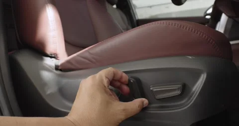 Men test buttons for electric adjustment of seats in the car. Stock Footage 244514985
