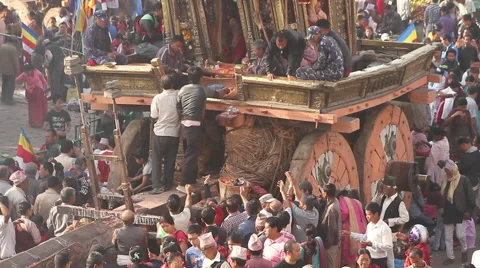 Men Throw Flowers onto Macchindranāth Stock Footage 49571500