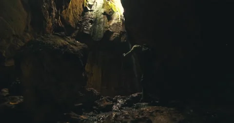 Men on a trail inside a giant cave Stock Footage 162524623