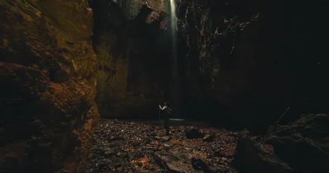 Men on a trail inside a giant cave Stock Footage 162524625