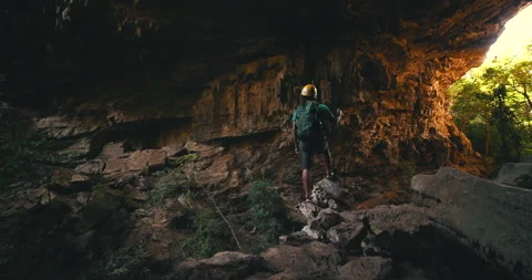 Men on a trail inside a giant cave Stock Footage 162524627
