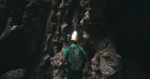 Men on a trail inside a giant cave Stock Footage 162524652