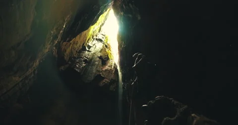 Men on a trail inside a giant cave Stock Footage 162524668