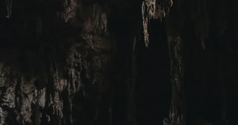 Men on a trail inside a giant cave Stock Footage 162524743