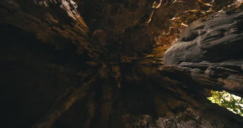 Men on a trail inside a giant cave Stock Footage 162524998