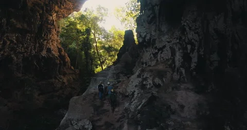 Men on a trail inside a giant cave Stock Footage 162525089